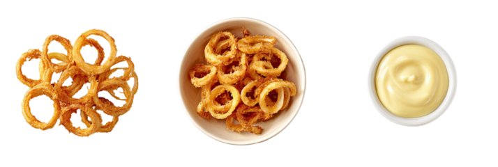 Onion rings in pile and bowl with creamy dip on black