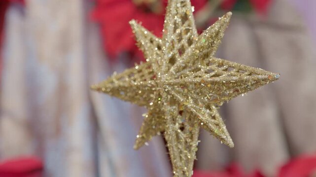 Catholic nativity scene details and decorations. Star. Christmas religious still life with red flowers prayer and faith detail closeup