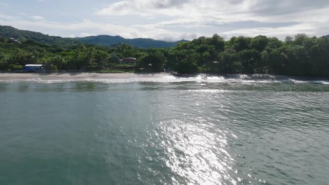 Punta Potrero, Costa Rica with ocean view and mountains with drone video moving in wide shot.