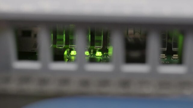 Steady green LEDs glowing inside PLC behind ventilation grille.