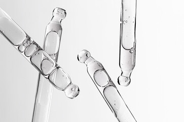 Skin serum in a pipette. A cosmetic product for body care. White background.