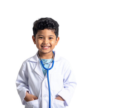 A smiling boy in a doctor's coat with a stethoscope, exuding confidence and joy.