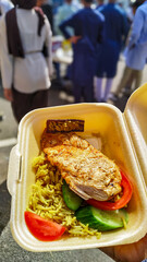 Turkish grilled chicken with spiced rice in takeaway box outdoor meal