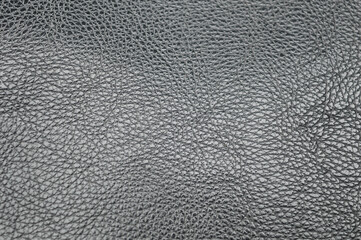 close-up macro texture of dark gray or black faux leather, vinyl surface. Represents rough material background, upholstery, fashion, abstract texture, and modern design concept.