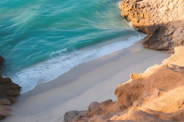 A serene aerial view of a secluded sandy beach with turquoise ocean waves gently lapping the shore and rugged golden cliffs bathed in warm sunlight