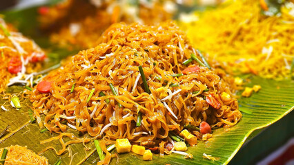 Noodle Delight: A vibrant display of Pad thai, freshly prepared noodles, artistically presented with various side dishes, embodying the essence of culinary artistry and flavor exploration.