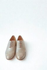 Classic tan leather oxford shoes on a white background