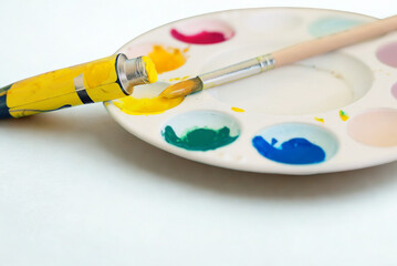 Artist s palette with paint tube and brush strokes