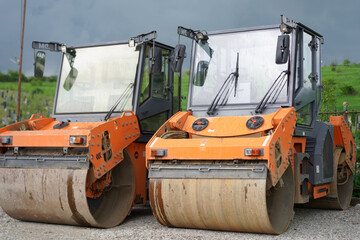 Heavy machinery preparing the ground at a construction site in the morning light