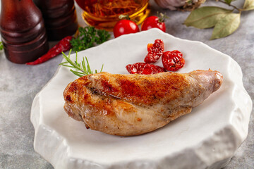 Roasted rabbit leg served rosemary