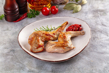Roasted rabbit leg served rosemary