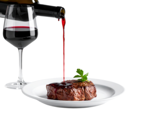 A succulent steak is topped with a rich red wine sauce, garnished with a sprig of parsley, alongside a glass of red wine.