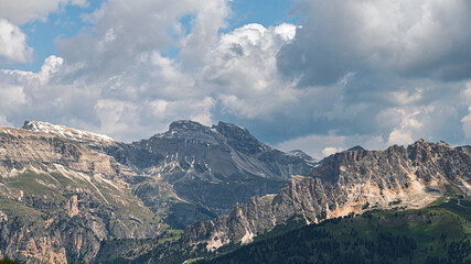 Fototapeta premium Sella mountain range and Sasso Pordoi images from Col Rodella with a cloudy sky in the background, Dolomites, Italy