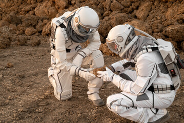 Astronaut team conducting geological analysis of Martian soil during planetary exploration.