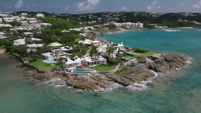 Aerial of the North Shore of Bermuda adorned with its unique colorful houses and whites roofs. video 5