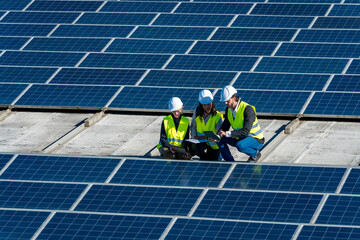 Engineers inspecting solar panels on rooftop power plant