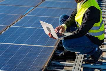 Engineer checking solar panels system with laptop