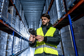 Man working in cold storage logistics warehouse scanning inventory