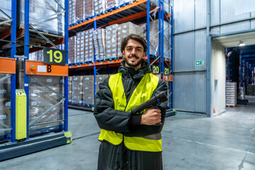 Worker smiling in cold storage warehouse inspecting inventory