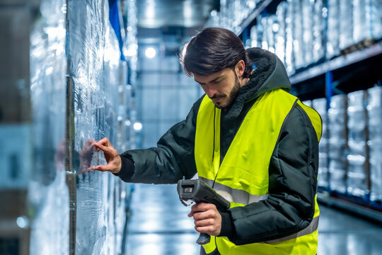 Warehouse worker scanning cargo in cold storage logistics