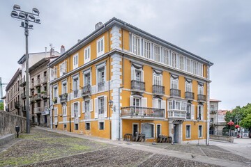 Fototapeta premium Elegant Historic Yellow Palace Building on Cobblestone Street in Lekeitio Old Town, Spain