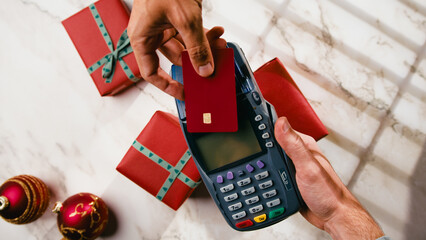 Electronic payment by card the POS for Christmas gift item during Black Friday