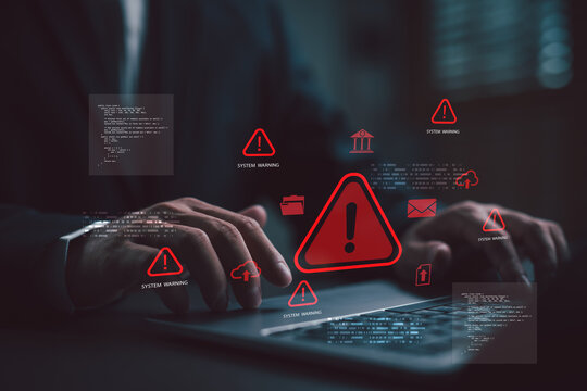 Hacker triggering cyberattack with red warning symbols on laptop screen, representing cybersecurity breach, data theft, system error, cybercrime alert, malware attack, and online security threat.