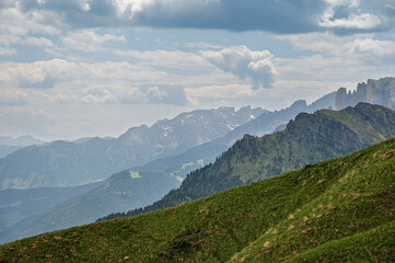 Sella mountain range and Sasso Pordoi images from Col Rodella with a cloudy sky in the background, Dolomites, Italy