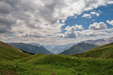 Sella mountain range and Sasso Pordoi images from Col Rodella with a cloudy sky in the background, Dolomites, Italy