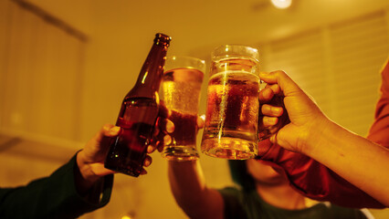 Close up friends hands clinking beer glasses in warm golden light, celebrating friendship teamwork. A joyful moment filled with laughter, unity, positive energy during relaxing evening gathering.