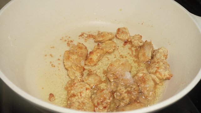The process of frying fish fillet until cooked brown