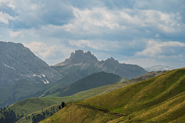 Fototapeta premium Sella mountain range and Sasso Pordoi images from Col Rodella with a cloudy sky in the background, Dolomites, Italy