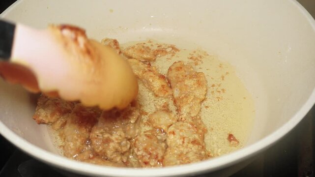 The process of frying fish fillet until cooked brown