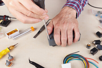 Repair of electrical devices at service workplace.