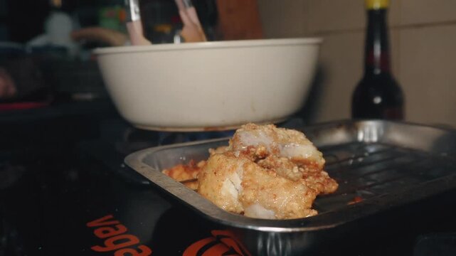 The process of frying fish fillet until cooked brown	