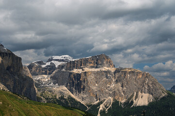 Sella mountain range and Sasso Pordoi images from Col Rodella with a cloudy sky in the background, Dolomites, Italy