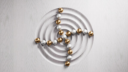 Gold and silver spheres rolling on concentric circles carved on wood