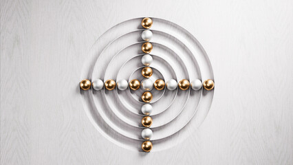 Gold and silver spheres forming a cross inside concentric circles on white wood