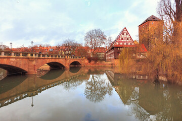 Old buildings and bridge reflected in water. Nuremberg, Bavaria