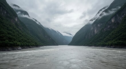 Misty River Gorge Through Verdant Mountains