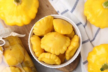 Fresh and pickled pattypan squashes on light grey table, flat lay