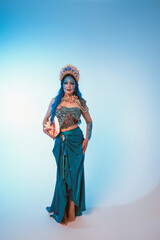 Attractive woman in a blue mermaid costume. Mermaid cosplay with body art