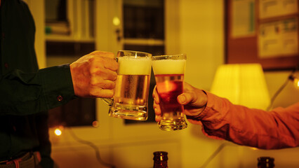 Close up friends hands clinking beer glasses in warm golden light, celebrating friendship teamwork. A joyful moment filled with laughter, unity, positive energy during relaxing evening gathering.