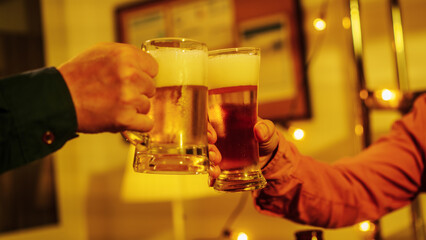 Close up friends hands clinking beer glasses in warm golden light, celebrating friendship teamwork. A joyful moment filled with laughter, unity, positive energy during relaxing evening gathering.