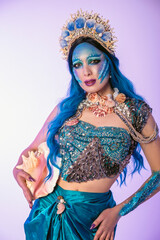 Attractive woman in a blue mermaid costume. Mermaid cosplay with body art