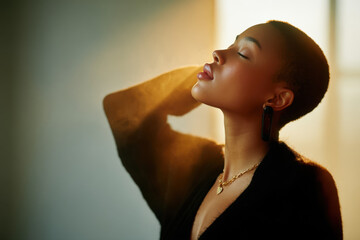 Young woman enjoying sunlight on her face, feeling peaceful