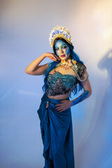 Attractive woman in a blue mermaid costume. Fantasy studio portrait of a mermaid model