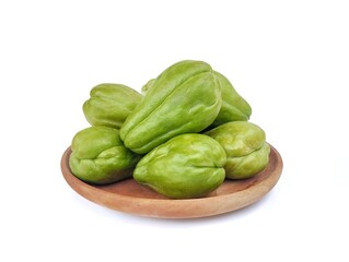 Fresh chayote on plate isolated on white background. High angle view 