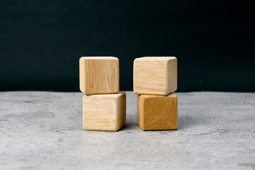Four empty wooden blocks on a table with empty space for your text, letters or numbers.