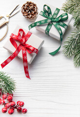 Christmas gifts wrapping on white wooden background